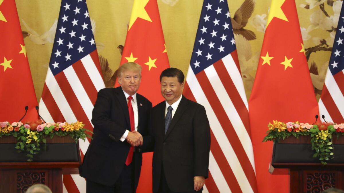 U.S. President Donald Trump and Chinese President Xi Jinping shake hands during a news conference at the Great Hall of the People in Beijing in 2017.