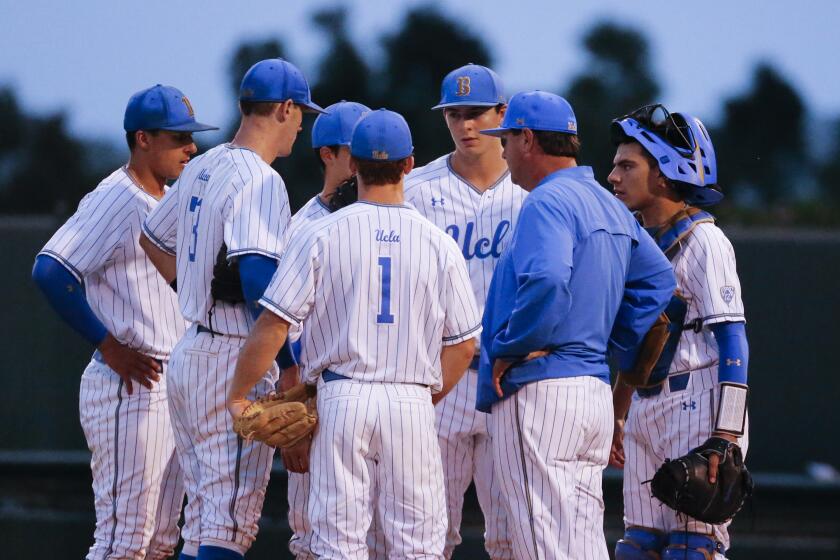 UCLA head coach John Savage talks to his team during an NCAA college baseball tournament super regional game in Los Angeles, Friday, June 7, 2019. Michigan won 3-2. (AP Photo/Ringo H.W. Chiu)