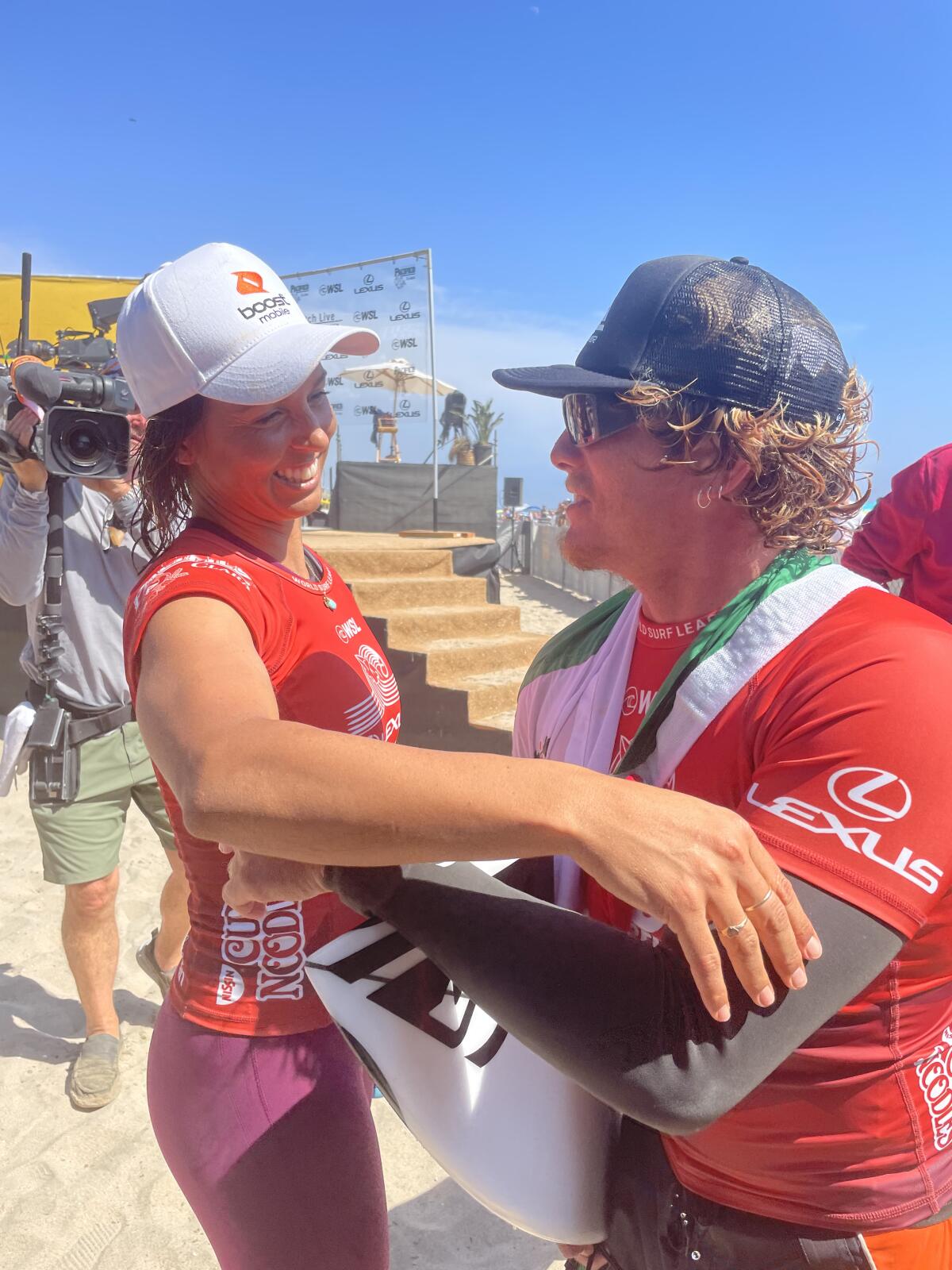 U.S. Open of Surfing winners Sally Fitzgibbons, left, and Alan Cleland congratulate each other on Sunday.