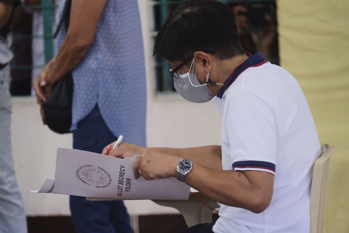 Presidential candidate Ferdinand Marcos Jr., the son of the late dictator, votes at a polling center in Batac City, Ilocos Norte, northern Philippines on Monday, May 9, 2022. Filipinos were voting for a new president Monday, with the son of an ousted dictator and a champion of reforms and human rights as top contenders in a tenuous moment in a deeply divided Asian democracy. (AP Photo)