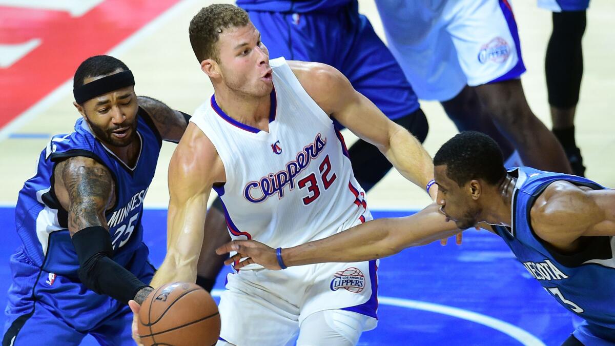 Clippers power forward Blake Griffin, center, is pressured by Minnesota Timberwolves guard Mo Williams, left, and forward Thaddeus Young during the Clippers' 127-101 win at Staples Center on Monday.