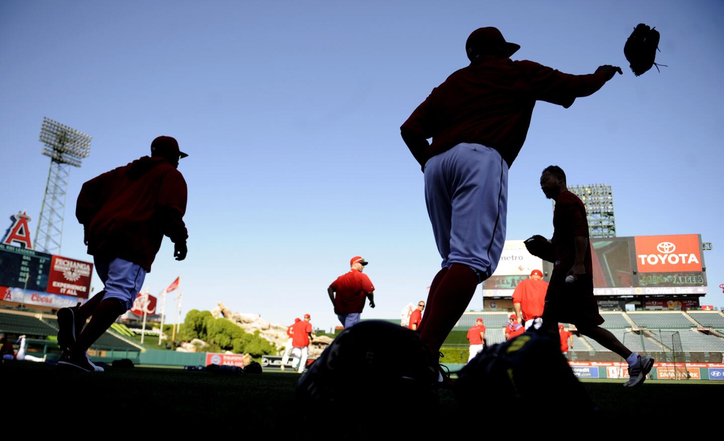 Angel players warm up before a game with the A's on opening day at Angel Stadium Tuesday.