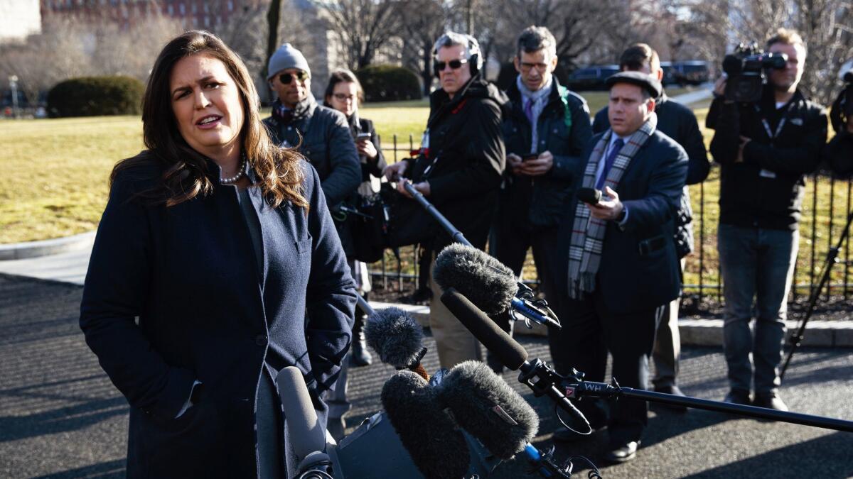 White House press secretary Sarah Huckabee Sanders talks with reporters outside the White House on Wednesday.