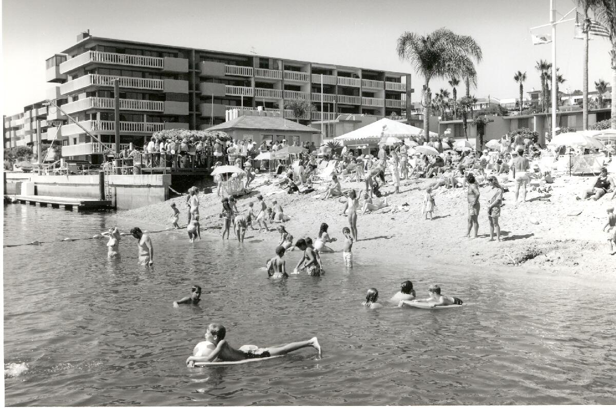 A shot of members of the Balboa Bay Club enjoying the beach in 1980.