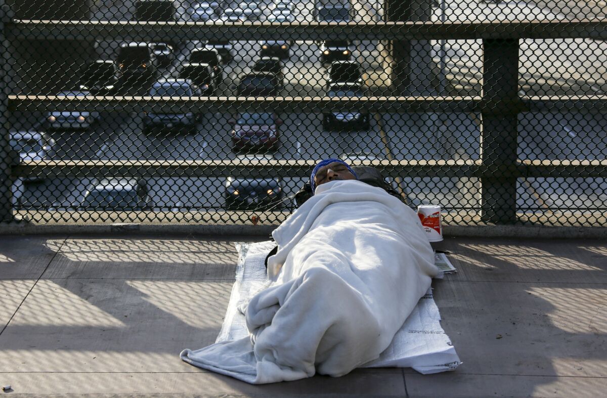 A homeless man on the Main Street bridge in downtown Los Angeles.