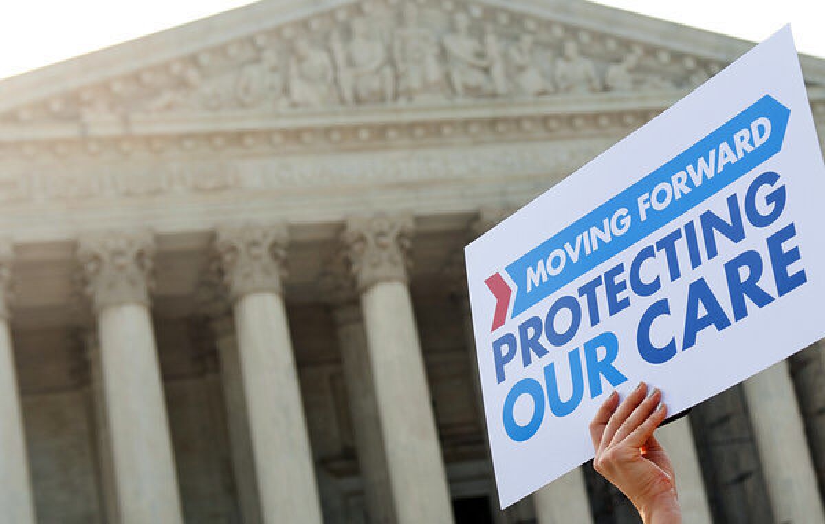 A supporter of the Affordable Care Act carries a sign outside the Supreme Court building in 2012.
