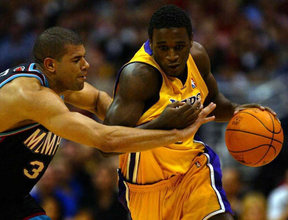 Kareem Rush, right, playing for the Lakers in 2004, fights off Shane Battier.