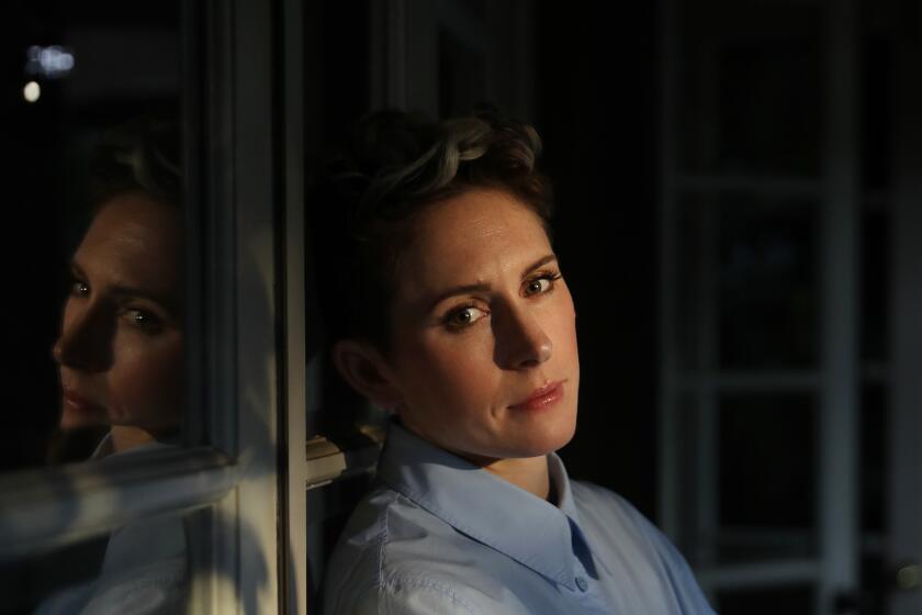 Ari Wegner, cinematographer of "The Power of the Dog", is photographed leaning on french doors