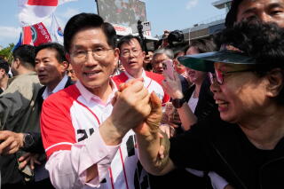 South Korea's presidential candidate Kim Moon-soo is greeted by a woman