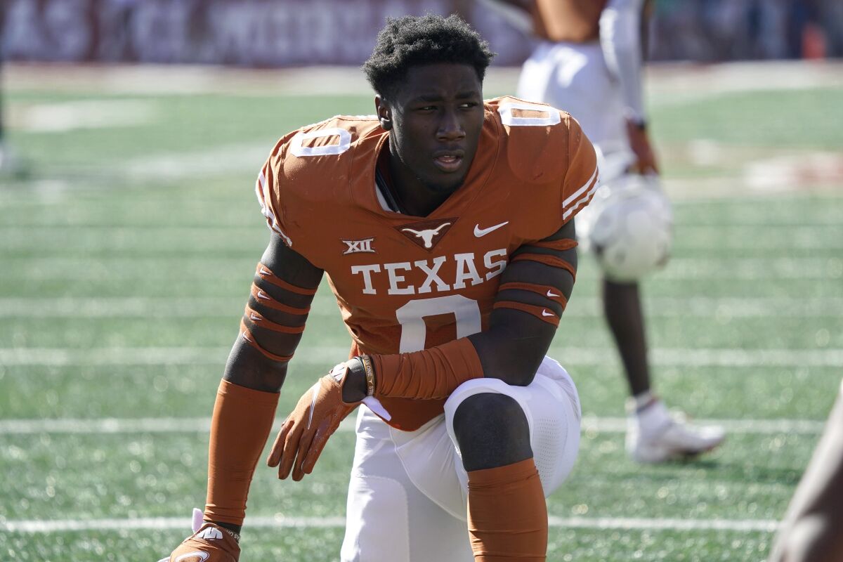 FILE - Texas linebacker DeMarvion Overshown pauses after taking the field before an NCAA college football game against Oklahoma State in Austin, Texas, Oct. 16, 2021. A year after the NCAA gave athletes Election Day off, football teams all over the country were practicing on the first Tuesday in November. Although the NCAA's Election Day rule remains in place, teams could pursue waivers if they wanted to practice. Texas practiced in the morning, which was fine with Overshown. “We still have all afternoon to go and vote and stuff,” he said. "It works better for us anyways, keep the normal schedule, not try to mix things up right in the middle of the season.” (AP Photo/Chuck Burton, File)