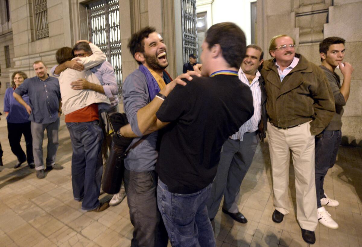 People celebrate Wednesday outside Congress in Montevideo, Uruguay, after lawmakers passed a marriage equality bill.