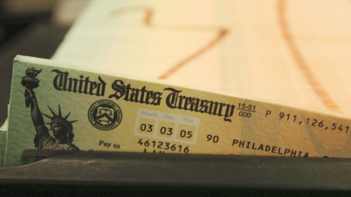 Social Security checks in a tray, shown in 2005, wait to be mailed out.