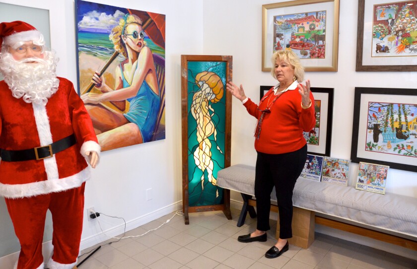 Balboa Island Gallery owner Kim Rossall describes the "Stained Glass by Cynthia" piece priced at $4,800.