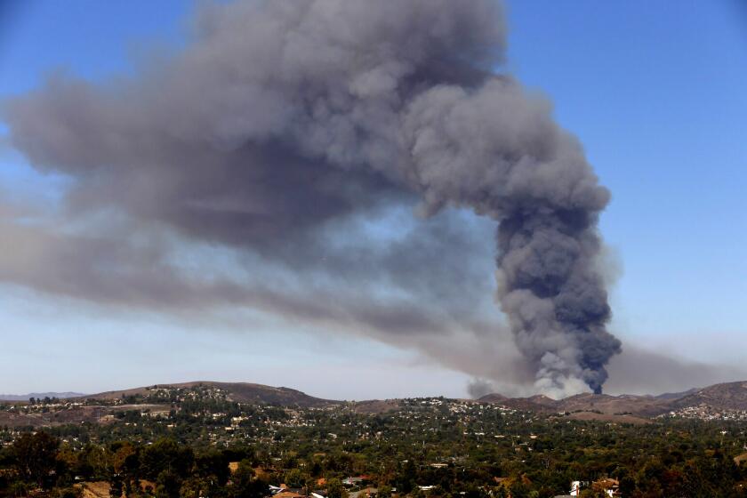 Brush fire puts up a huge plume of smoke in the hills above Simi Valley.
