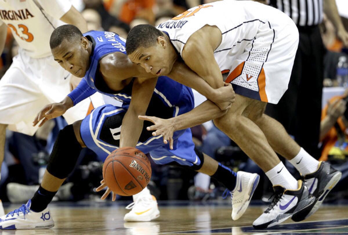 Duke's Rasheed Sulaimon, left, and Virginia's Malcolm Brogdon battle for a loose ball in the first half of the ACC tournament final on Sunday in Greensboro, N.C.