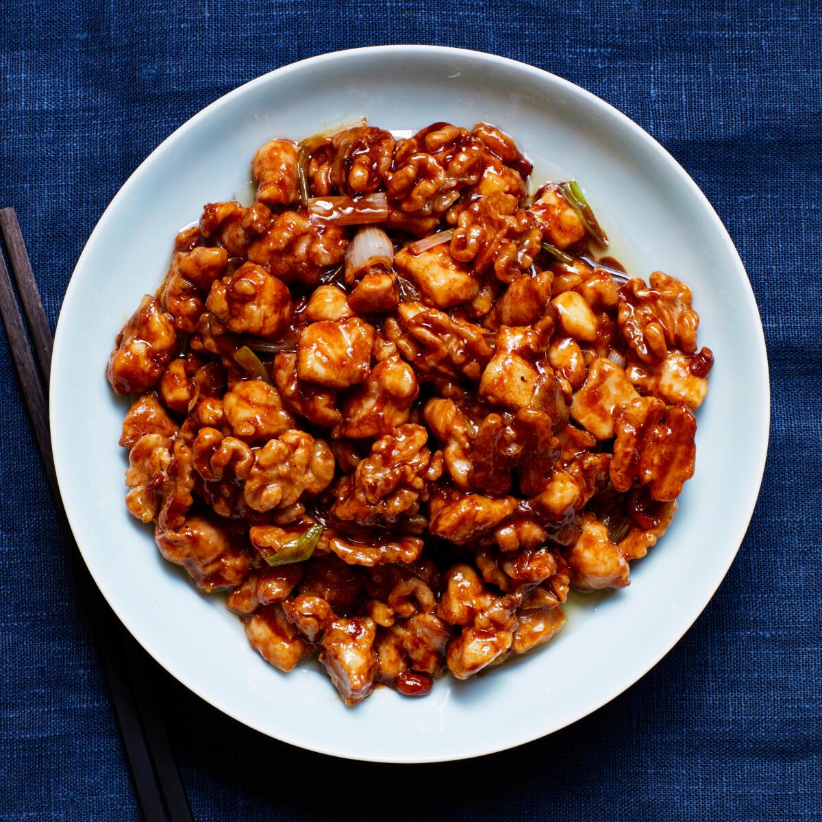 A salty-sweet fermented yellow bean paste sauce coats chicken and walnuts.