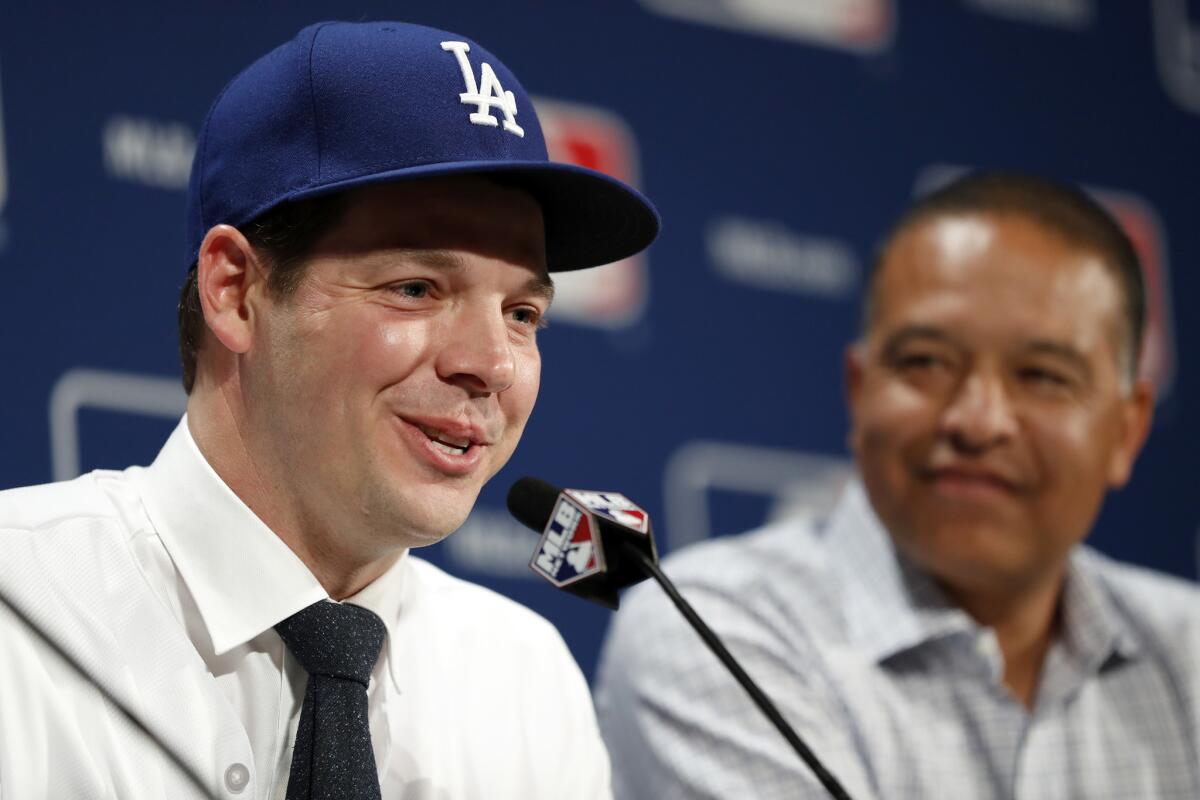 Dodgers pitcher Rich Hill, left, speaks as Manager Dave Roberts looks on during a news conference at the winter meetings on Dec. 5 in Oxon Hill, Md.