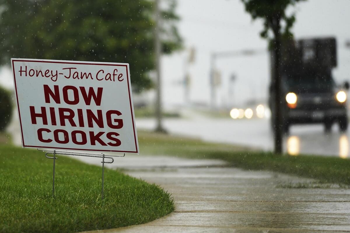 A hiring sign is shown in Downers Grove, Ill., on June 24. 
