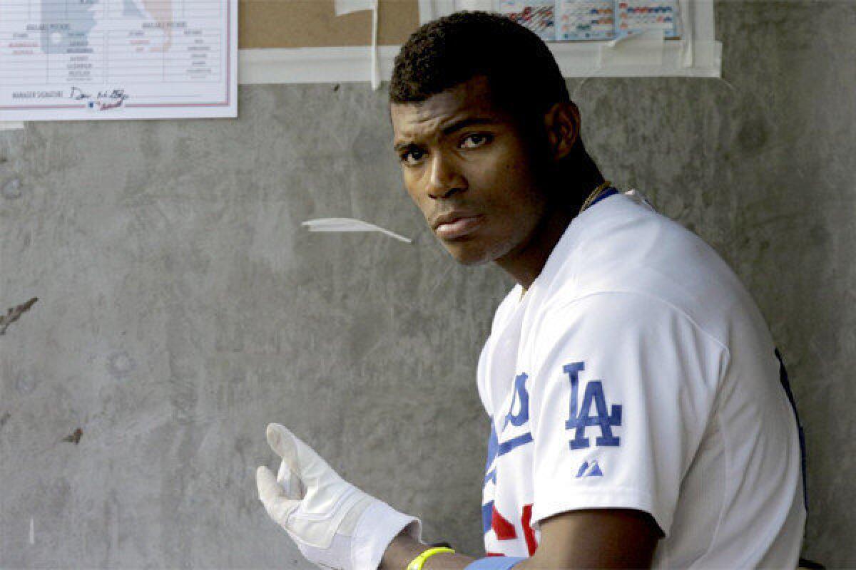 Dodgers rookie sensation Yasiel Puig has been scratched from the Dodgers' lineup Tuesday because of a strained right shoulder.