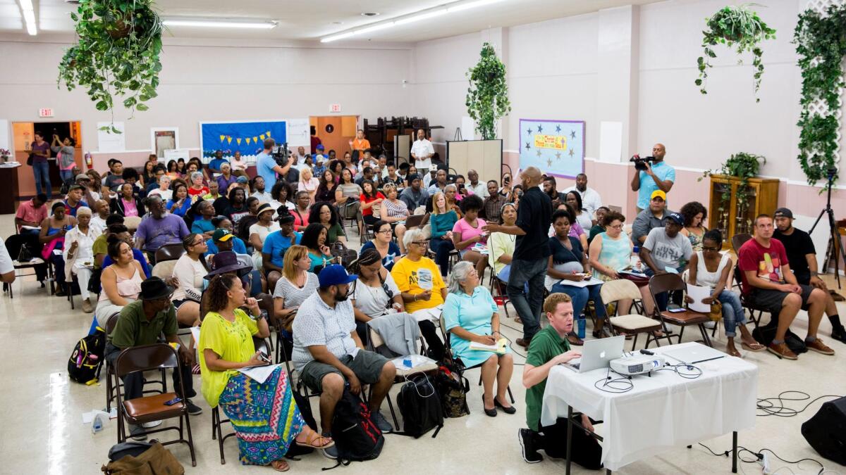 People gather for a town hall meeting to discuss gentrification and the Baldwin Hills Crenshaw Plaza redevelopment plan at Christ Temple Church Cathedral.