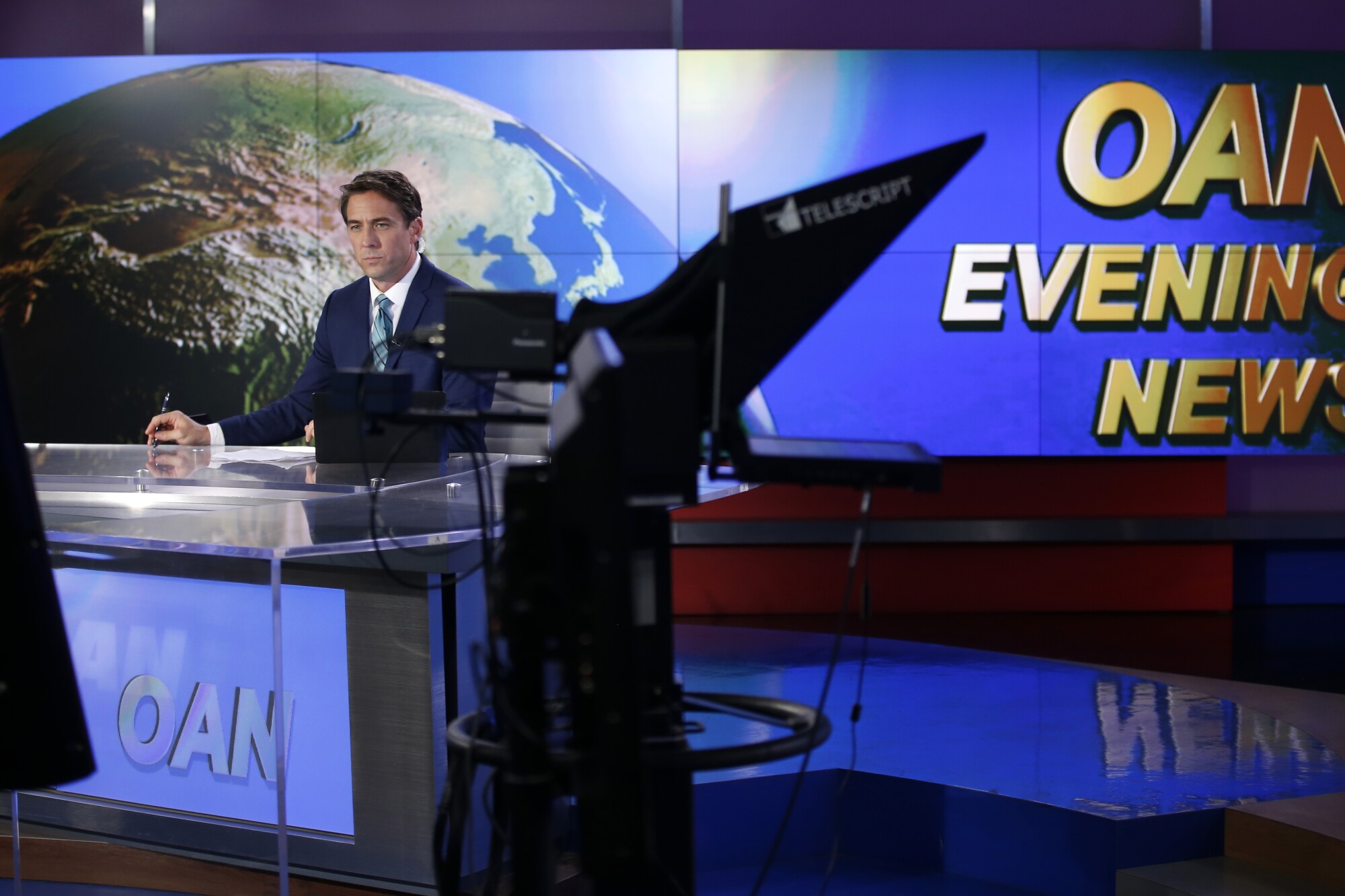Patrick Hussion waits for a break while hosting an evening news segment at San Diego-based One America News on Sept. 5, 2019.