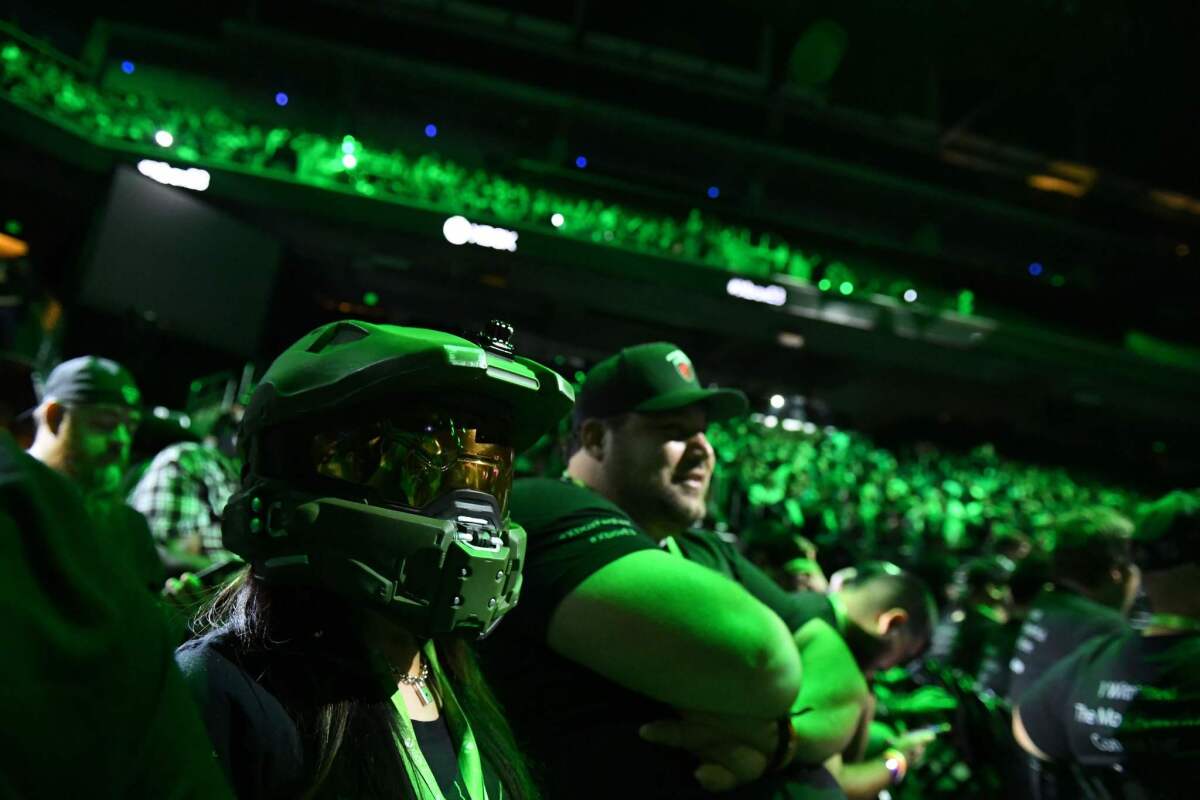 An attendee wears the helmet of Master Chief from the "Halo" franchise during a Microsoft at the Galen Center in Los Angeles in June. (Robyn Beck / AFP/Getty Images)