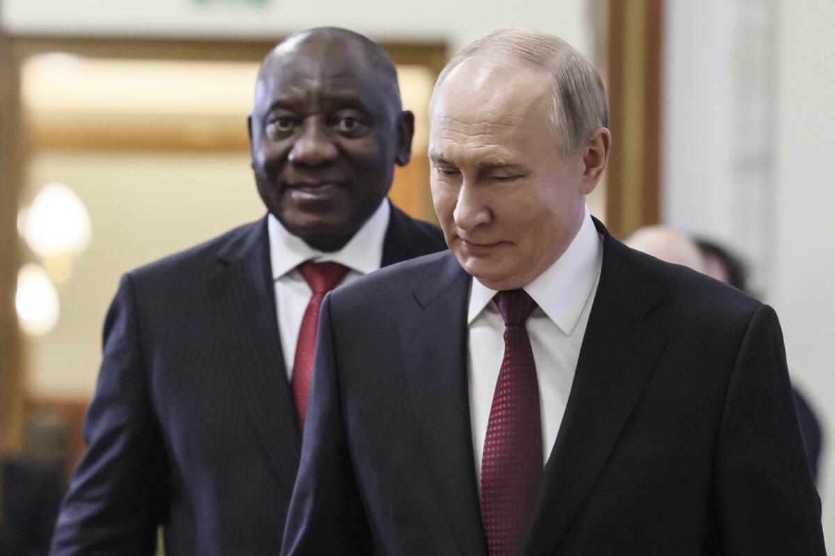 Russian President Vladimir Putin, front, walks with South African President Cyril Ramaphosa in Kazan, Russia.