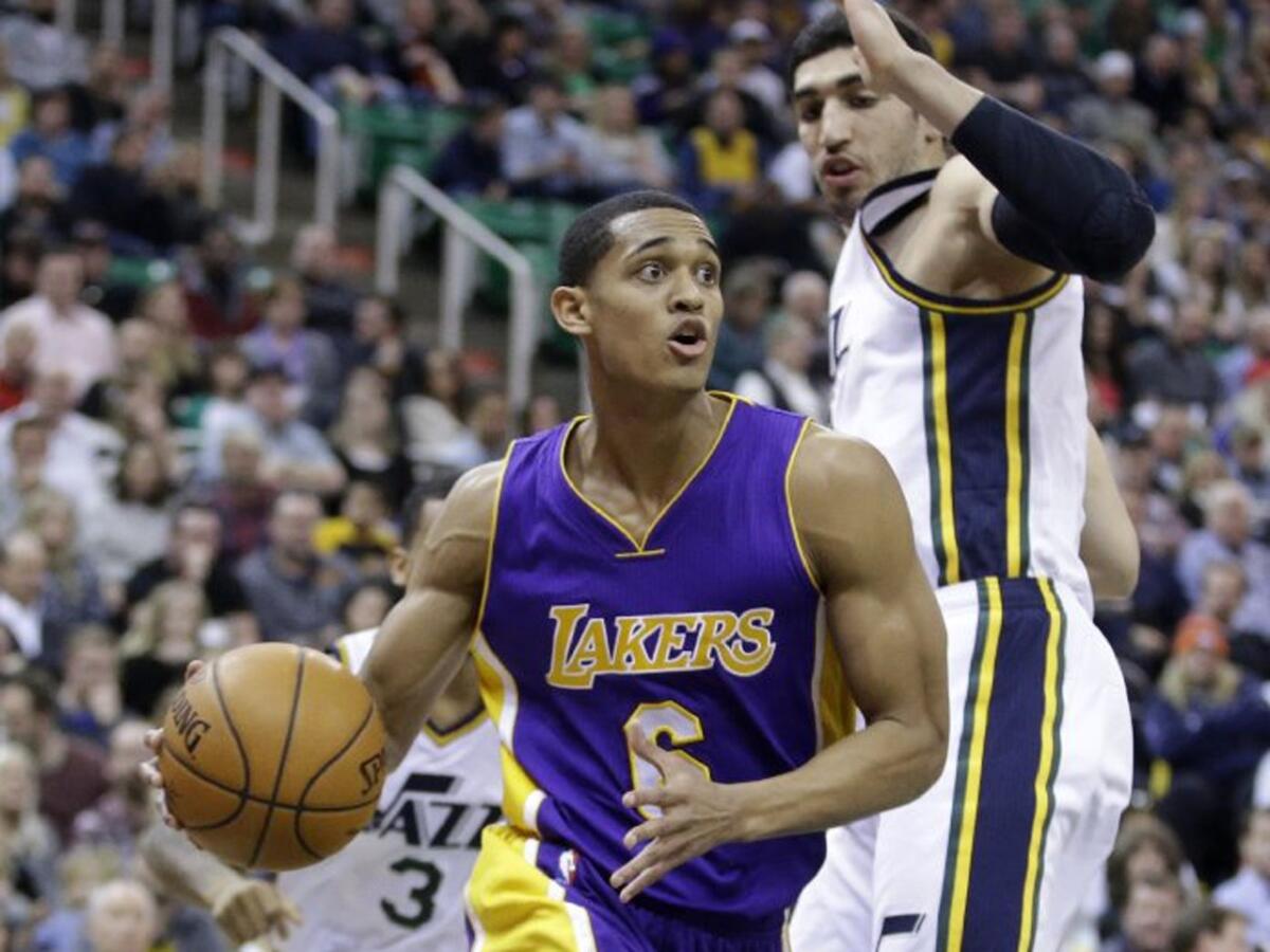 Lakers guard Jordan Clarkson drives right by Jazz center Enas Kanter in the second half.