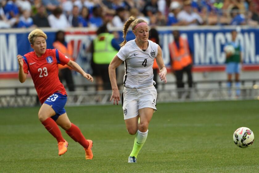 Becky Sauerbrunn, right, tries to get away from South Korea's Lee Sodam during a friendly match May 30 in Harrison, New Jersey.