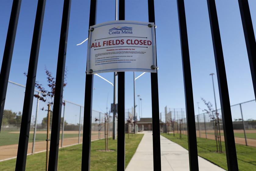 A closure noticed is posted on the north gate at TeWinkle Athletic Complex in Costa Mesa on Saturday, April 25. Local PONY baseball leagues are sidelined by the coronavirus and are unsure if they will be able to resume play at all this season.