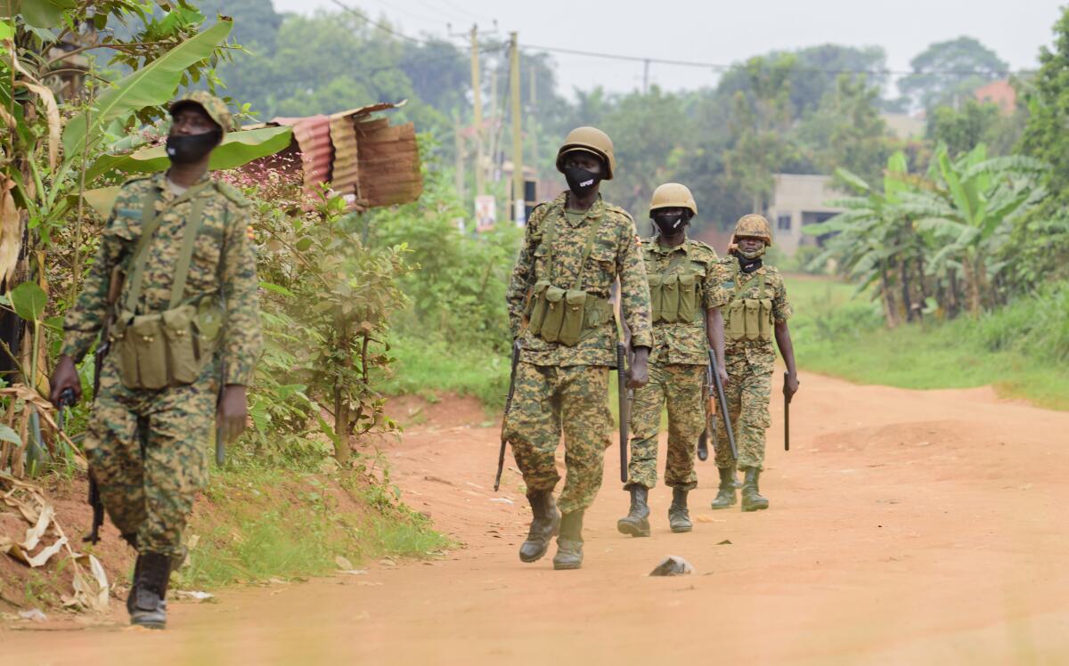 Soldiers patrol outside the home of opposition challenger Bobi Wine in Kampala, Uganda. 
