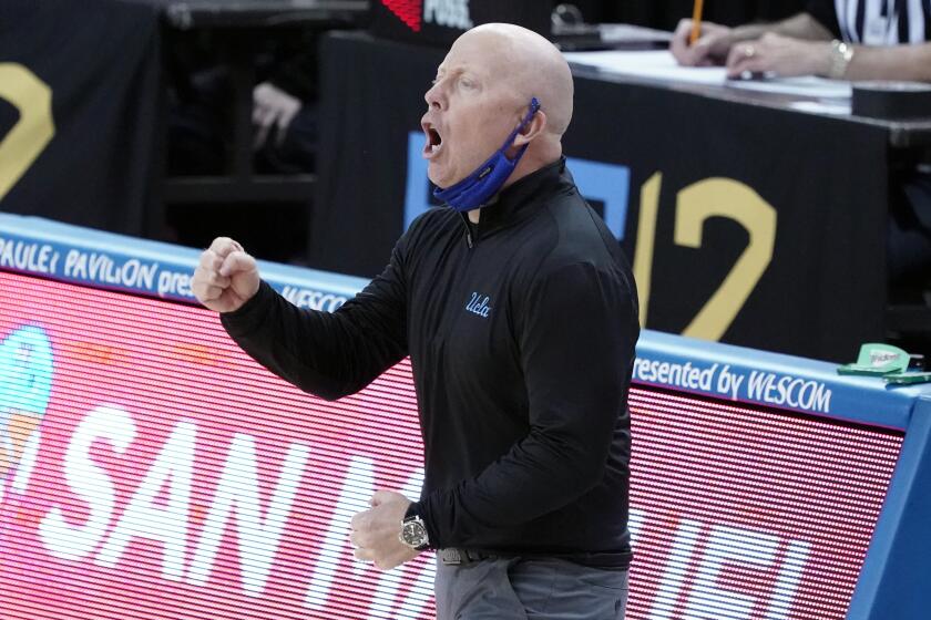UCLA head coach Mick Cronin yells instructions during the first half of an NCAA college basketball game.