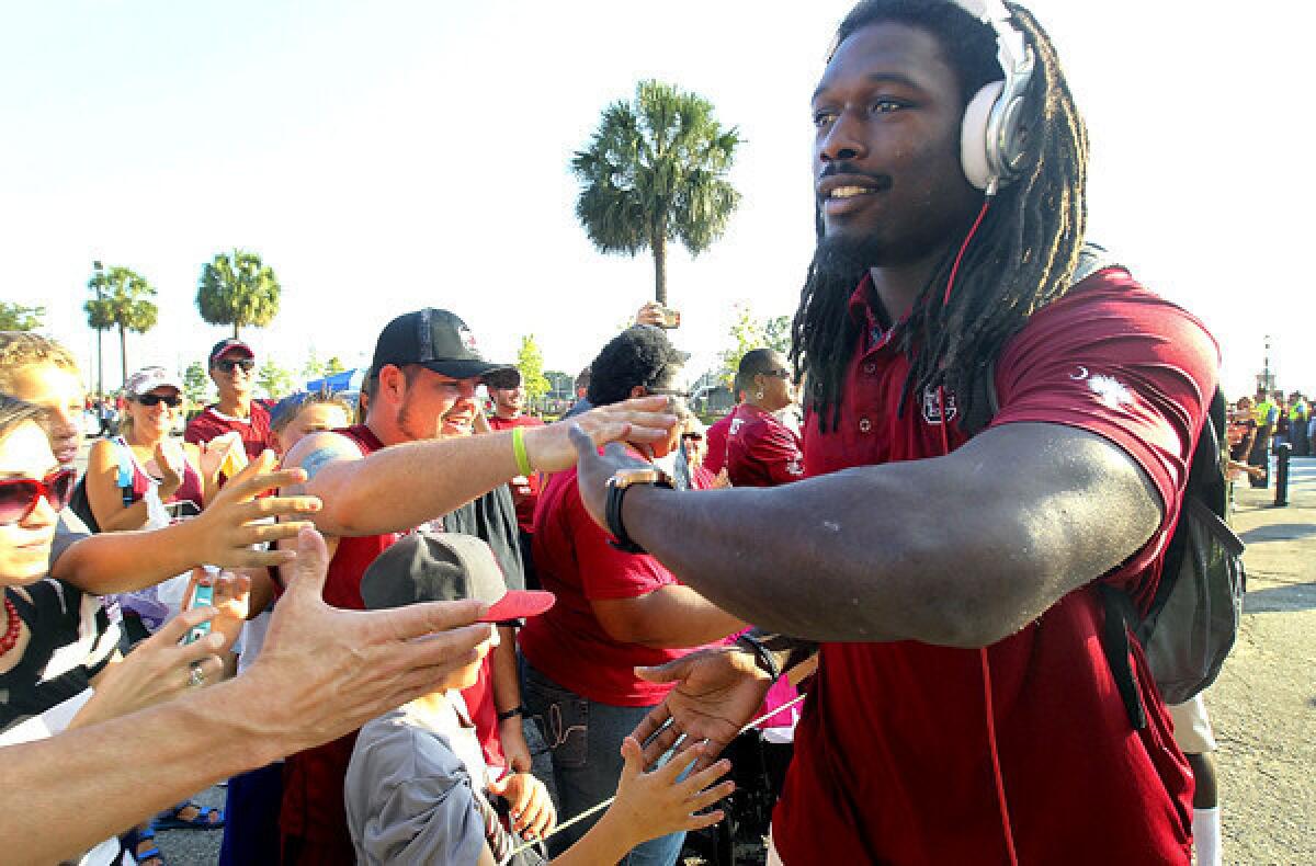 South Carolina defensive end Jadeveon Clowney greets fans during the Gamecock Walk before before a game against Kentucky at Williams-Brice Stadium in Columbia, S.C., on Saturday.