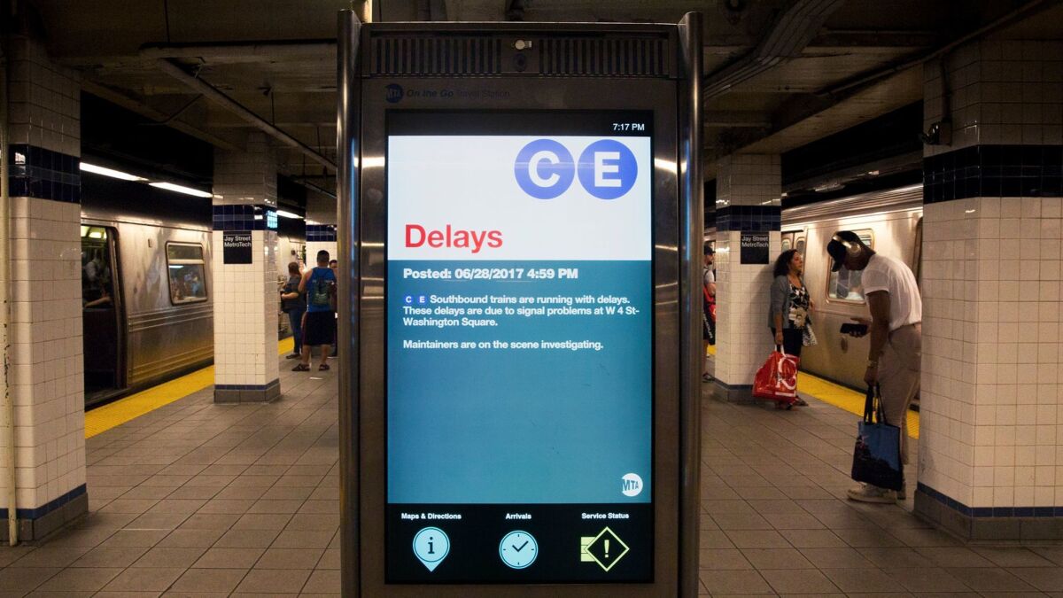 A sign warns of delays on the C and E trains due to signal problems.