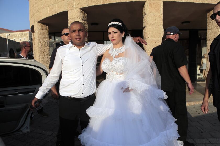 Mahmoud Mansour, left, a Muslim Arab from Jaffa, and Morel Malka, a Jewish Israeli who converted to Islam, are shown Sunday on their wedding day.