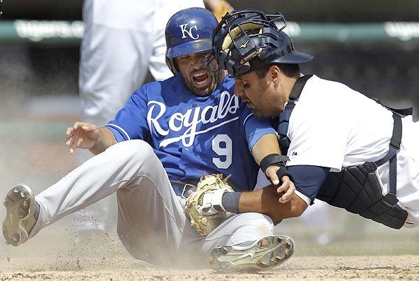 David De Jesus of the Kansas City Royals slides in safely to home after Detroit Tigers catcher Gerald Laird dropped the ball in a game at Comerica Park in Detroit. The Royals won, 7-3.