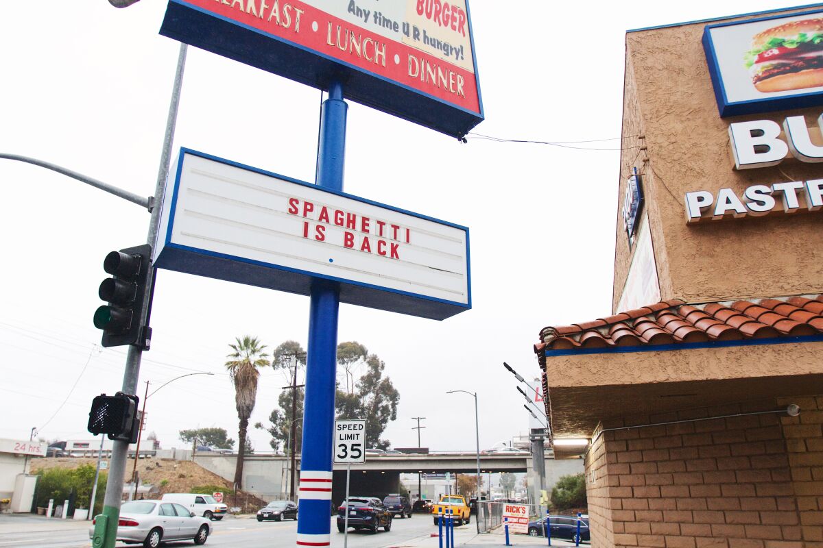 A photo of the exterior of restaurant Rick's Drive In & Out, in Frogtown, with the "SPAGHETTI IS BACK" marquee on view.
