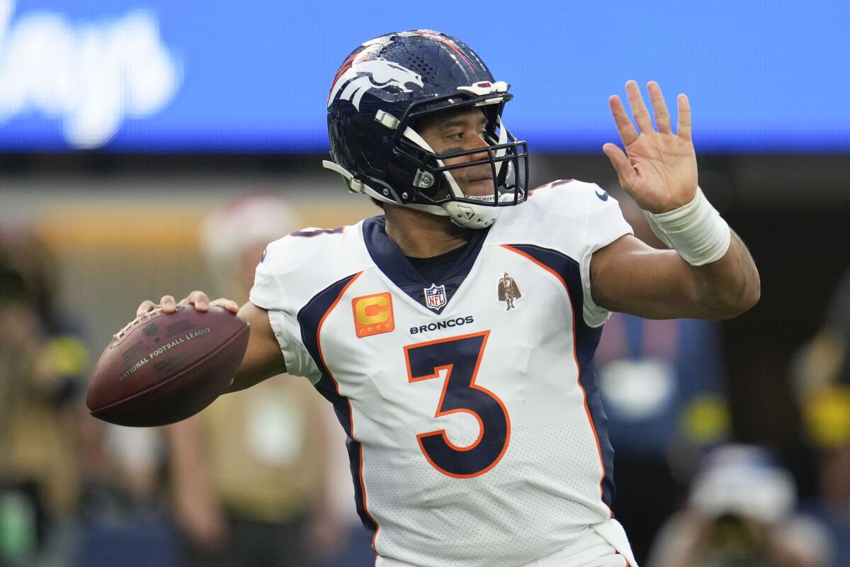 Denver Broncos quarterback Russell Wilson passes during the first half against the Rams.