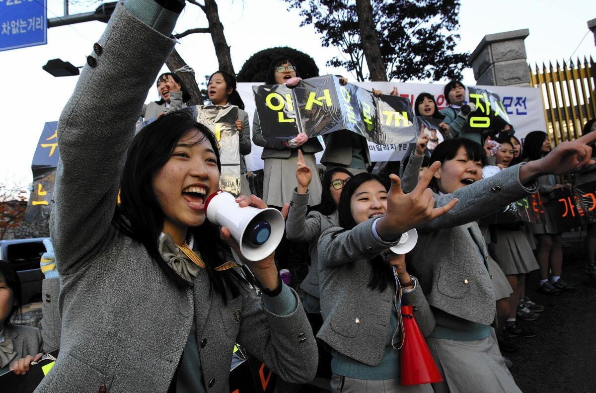 South Korean students cheer their seniors' success in the Scholastic Aptitude Test. Students from Shanghai, Hong Kong, Singapore, Taiwan, Japan and South Korea were among the highest-ranking groups in math, science and reading in test results released earlier this month by the Program for International Student Assessment.