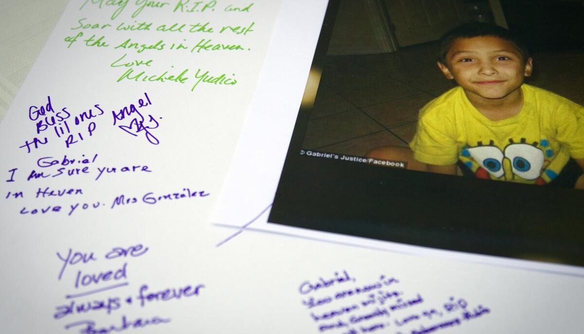 Tributes are written on a poster board during a memorial service for Gabriel Fernandez, 8.