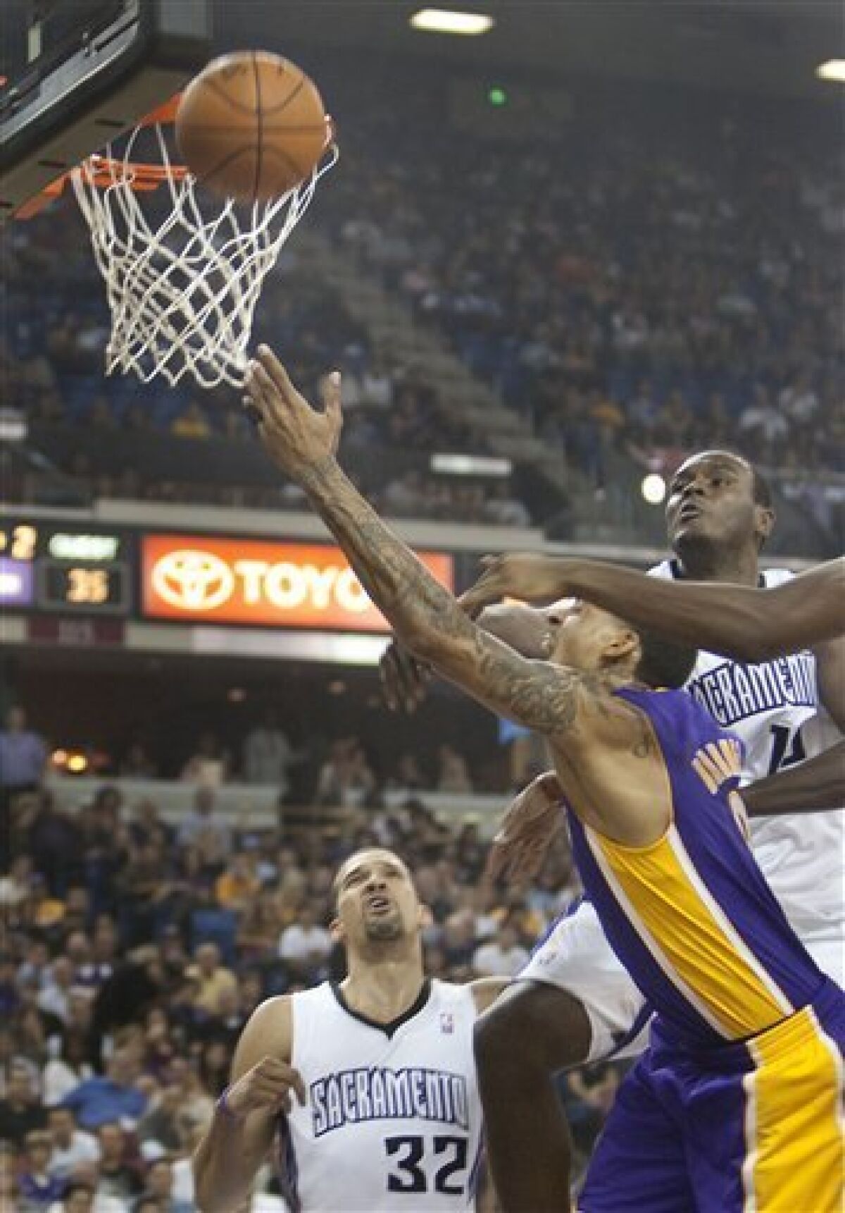 Los Angeles Lakers' Matt Barnes, center, drives for a a basket in the first half as the Sacramento Kings' Francisco Garcia (32), left and Samuel Dalembert (10), right guard on the play in the first half in Sacramento, Calif., Wednesday Nov. 3, 2010. (AP Photo/Robert Durell)