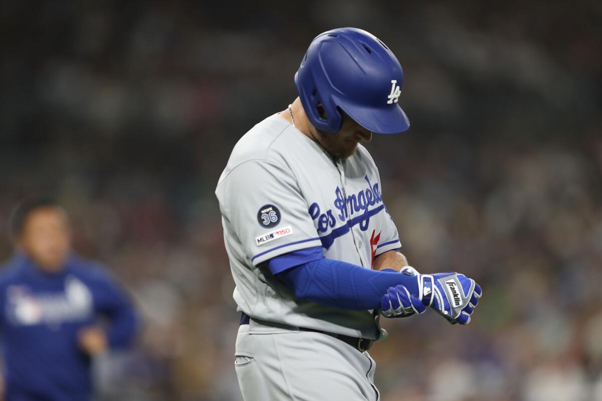 Dodgers' Max Muncy reacts after being hit by a pitch during the fifth inning against the San Diego Padres on Wednesday in San Diego.