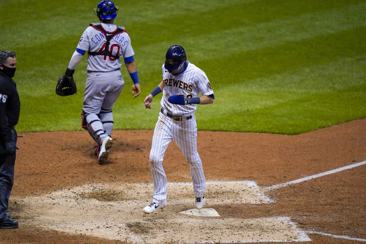 Milwaukee Brewers' Christian Yelich scores the game-winning run from third on a sacrifice fly by Ryan Braun during the ninth inning of a baseball game against the Chicago Cubs Friday, Sept. 11, 2020, in Milwaukee. The Brewers won 1-0. (AP Photo/Morry Gash)