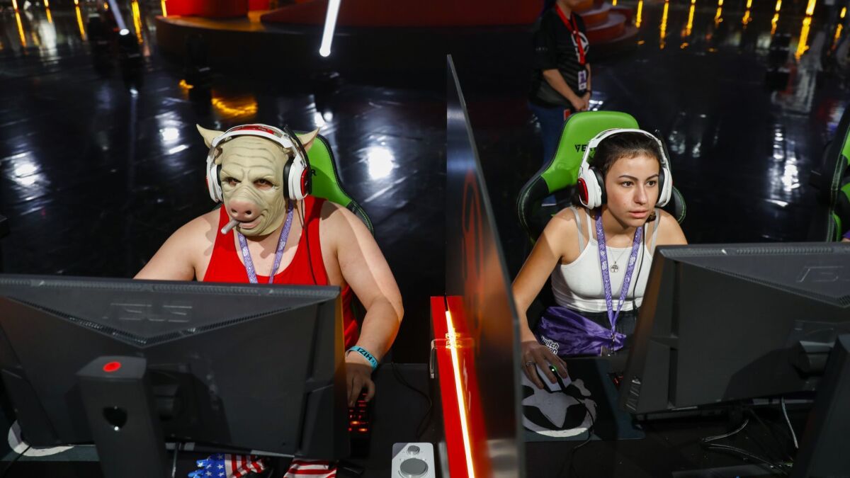 Two players compete in an "H1Z1" gaming tournament, with a grand prize of $500,000, on opening day of Twitchcon at the Long Beach Convention Center in October 2017.