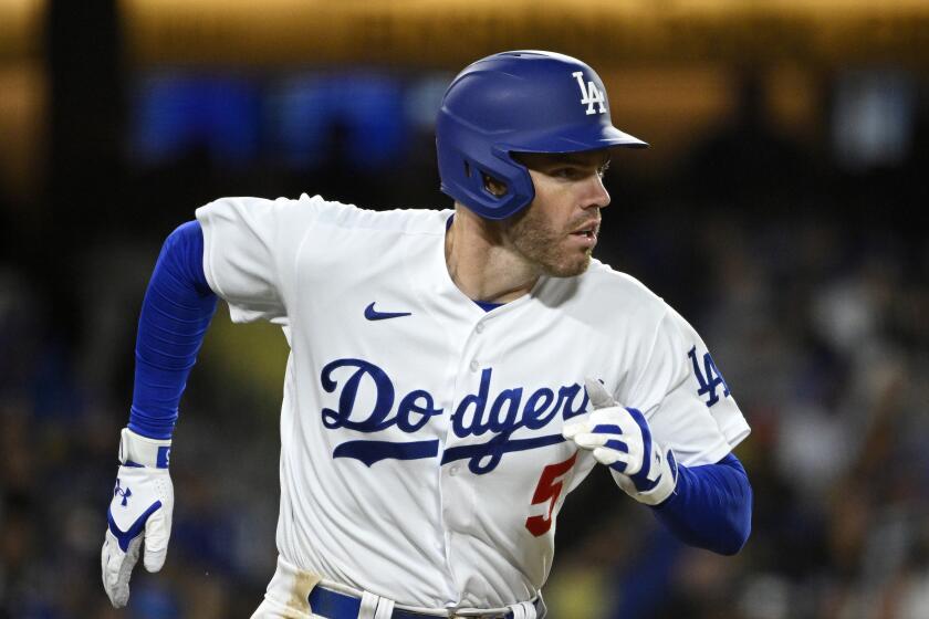 Los Angeles Dodgers' Freddie Freeman runs to first after hitting a double during the fifth inning.