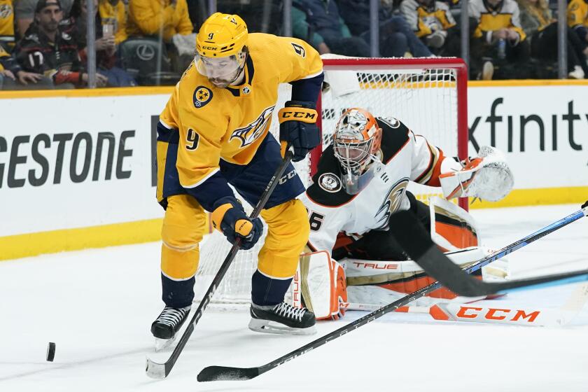 Nashville Predators' Filip Forsberg (9) reaches for the puck in front of Anaheim Ducks goaltender John Gibson (36) in the second period of an NHL hockey game Thursday, March 10, 2022, in Nashville, Tenn. (AP Photo/Mark Humphrey)