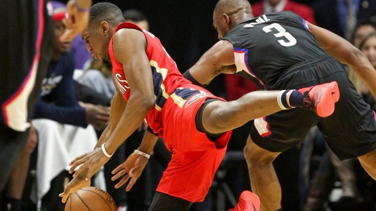Pelicans guard Langston Galloway and Clippers guard Chris Paul battle for a ball during the first half of a game on Dec. 10.