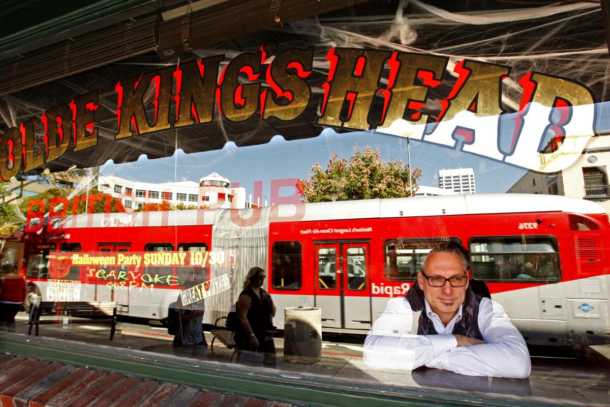 Paul Boettcher, co–owner of Ye Olde King's Head, watches traffic pass in front of his Santa Monica restaurant and pub.