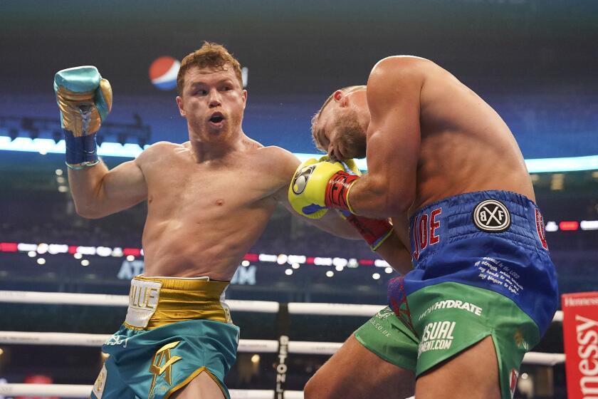 FILE - In this May 8, 2021, file photo, Canelo Alvarez, left, hits Billy Joe Saunders during a boxing match in Arlington, Texas. Alvarez has agreed to face unbeaten Caleb Plant on Nov. 9 in Las Vegas in a bid to become the undisputed super middleweight world champion. (AP Photo/Jeffrey McWhorter, File)