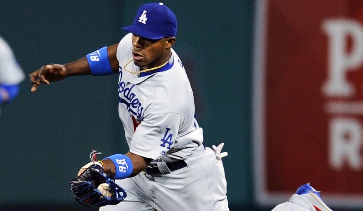 Dodgers outfielder Yasiel Puig makes a running catch during a game against the Angels on May 19.